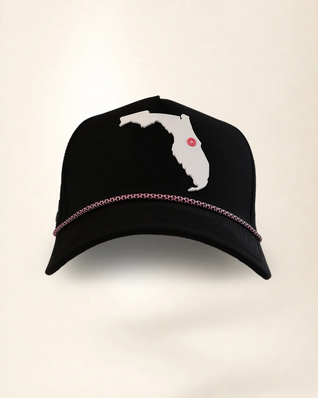 A black baseball cap featuring a white silhouette patch of the state of Florida on the front with a small red dot marking, and a thin metallic rose gold chain trim across the brim.