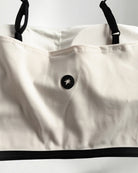  white and black strapless top on a plain background