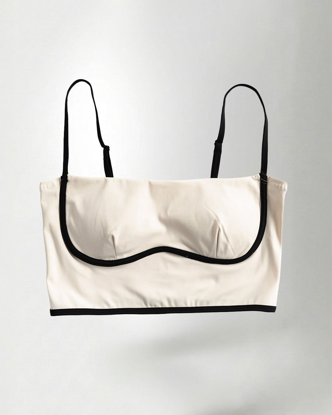 white and black strapless top on a plain background