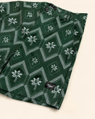 The Club Palm Hybrid Swim Shorts in Palm Green geometric diamond print with palm tree details, zippered pockets, and versatile lifestyle fit for pool, patio, boat, and bar activities.