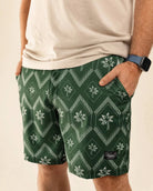 The Club Palm Hybrid Swim Shorts in Palm Green with geometric diamond and palm tree print, zippered pockets, styled for versatile Florida lifestyle