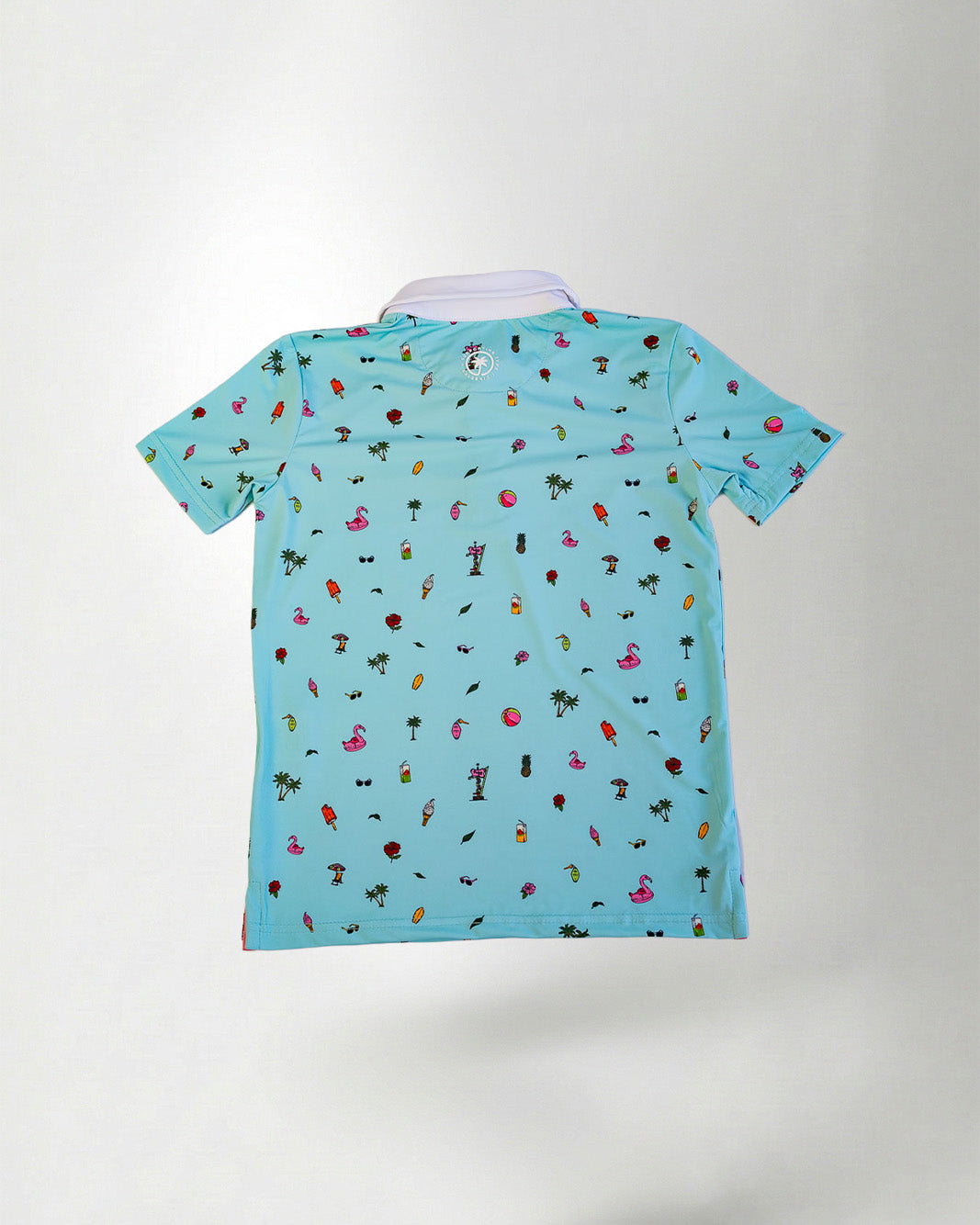 Young boy wearing a light blue polo shirt with colorful patterns on a plain background