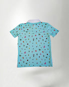 Young boy wearing a light blue polo shirt with colorful patterns on a plain background