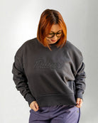 Person wearing a dark gray sweatshirt with 'Palmr' branding on a light gray background