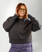 Person wearing a dark gray sweatshirt with 'Palmr' branding on a light gray background