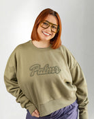 Person wearing a green sweatshirt with 'Palmr' text on a plain background
