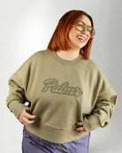 Person wearing a green sweatshirt with 'Palmr' text on a plain background