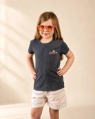 Black mineral wash The Evening Palm Kids Tee with Palmr logo and beach sunset graphic, soft heather cotton-poly blend.