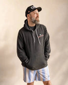 The Evening Palm Hoodie in dark heather grey with Palmr logo and sunset graphic, lightweight cotton-poly fleece for versatile casual wear