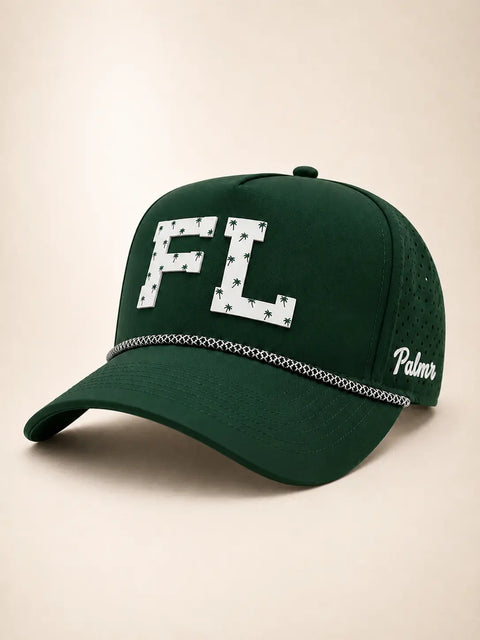 The FL Signature Hat (Green): dark green rope snapback with FL in white palm-print letters, perforated sides, Palmr script logo.