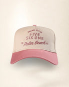 A two-tone baseball cap with a light beige crown and a pink brim, featuring pink embroidered text that reads 'PALMR STYLE FIVE SIX ONE 2 Palm Beach 25'.