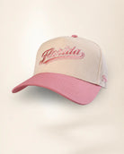 A baseball cap with a cream-colored front panel and a dusty pink brim, featuring 'Florida' embroidered in pink script on the front.