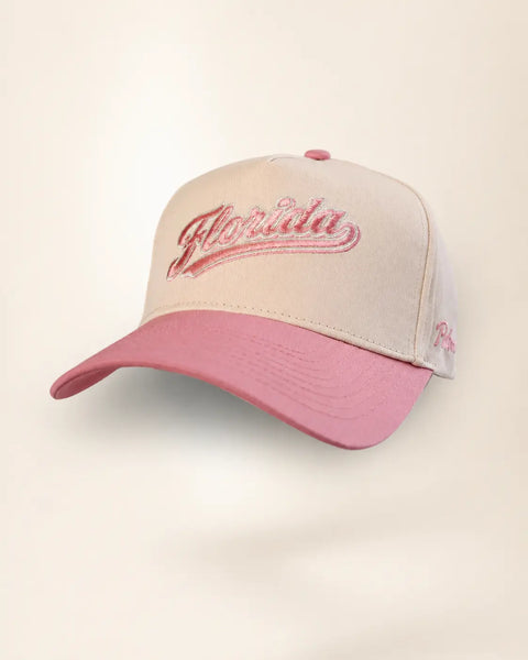 The Florida Heritage Hat (Pink): cream and dusty pink two-tone heritage cap with Florida embroidered in pink script, Palmr script logo on the side.