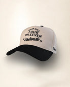 A black and off-white trucker cap with embroidered text reading 'PALMR STYLE FOUR OH SEVEN Orlando 24' on the front panel, shown against a plain light beige background.