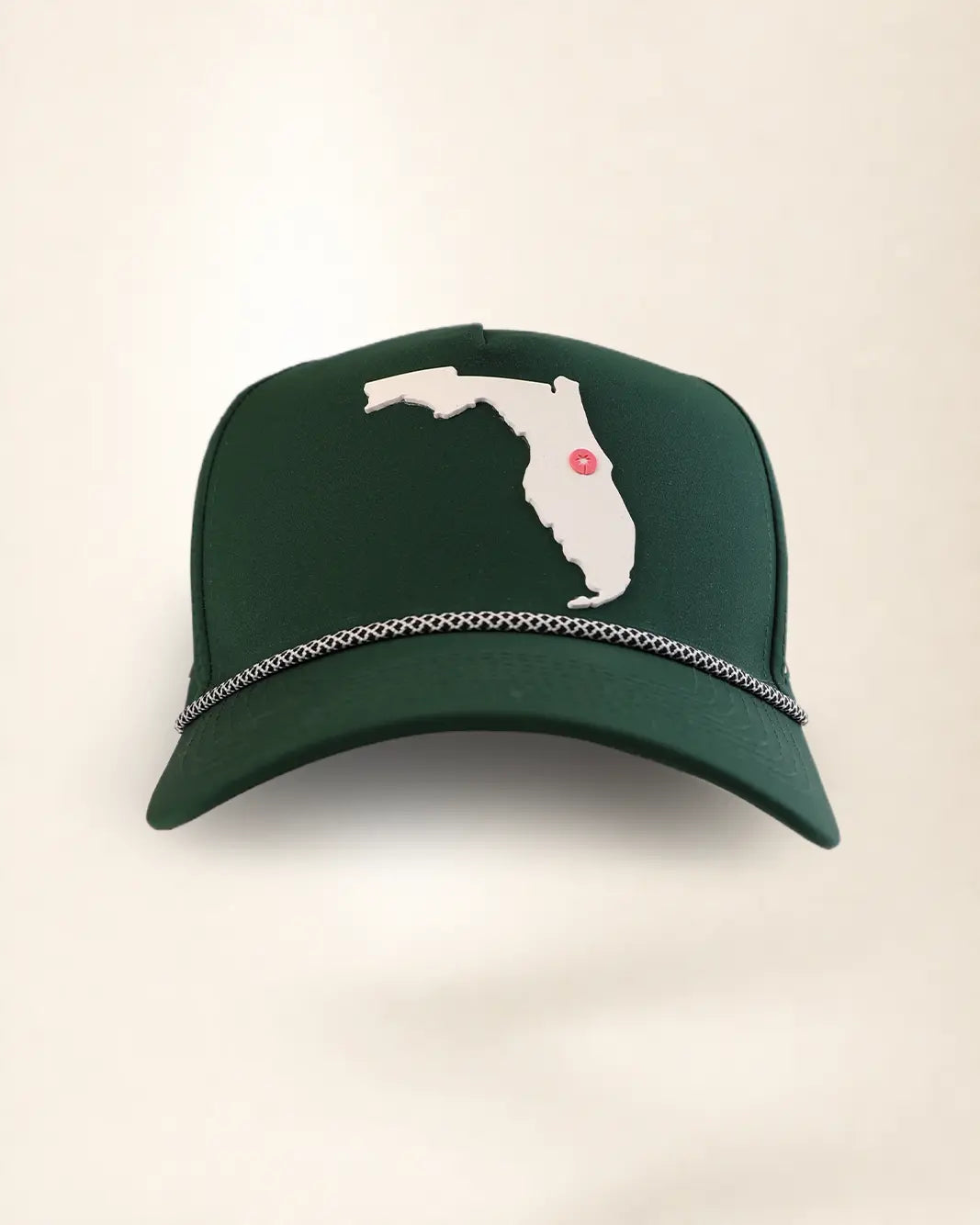 A dark green baseball cap featuring a white silhouette patch of the state of Florida with a small red dot marking, and a silver chain detail across the brim, set against a plain off-white background.