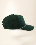 A dark green baseball cap with perforated side panels and a silver chain detail along the edge of the brim, shown against a plain light beige background.