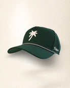 A dark green baseball cap with a white palm tree logo on the front, a silver chain detail across the brim, and 'Palmer' embroidered in white on the side, set against a plain off-white background.