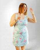 Woman wearing a tropical pattern dress against white background 