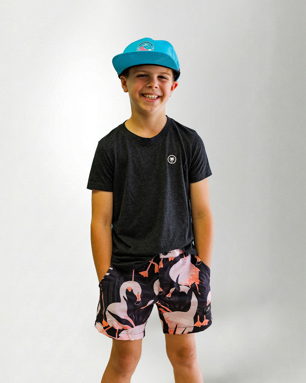 Person wearing a black patterned shirt and shorts with a white bird design on a plain background