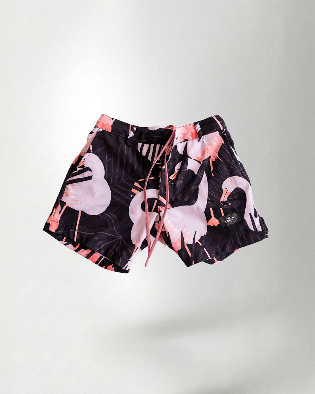 Black patterned shirt and shorts with a white bird design on a plain background