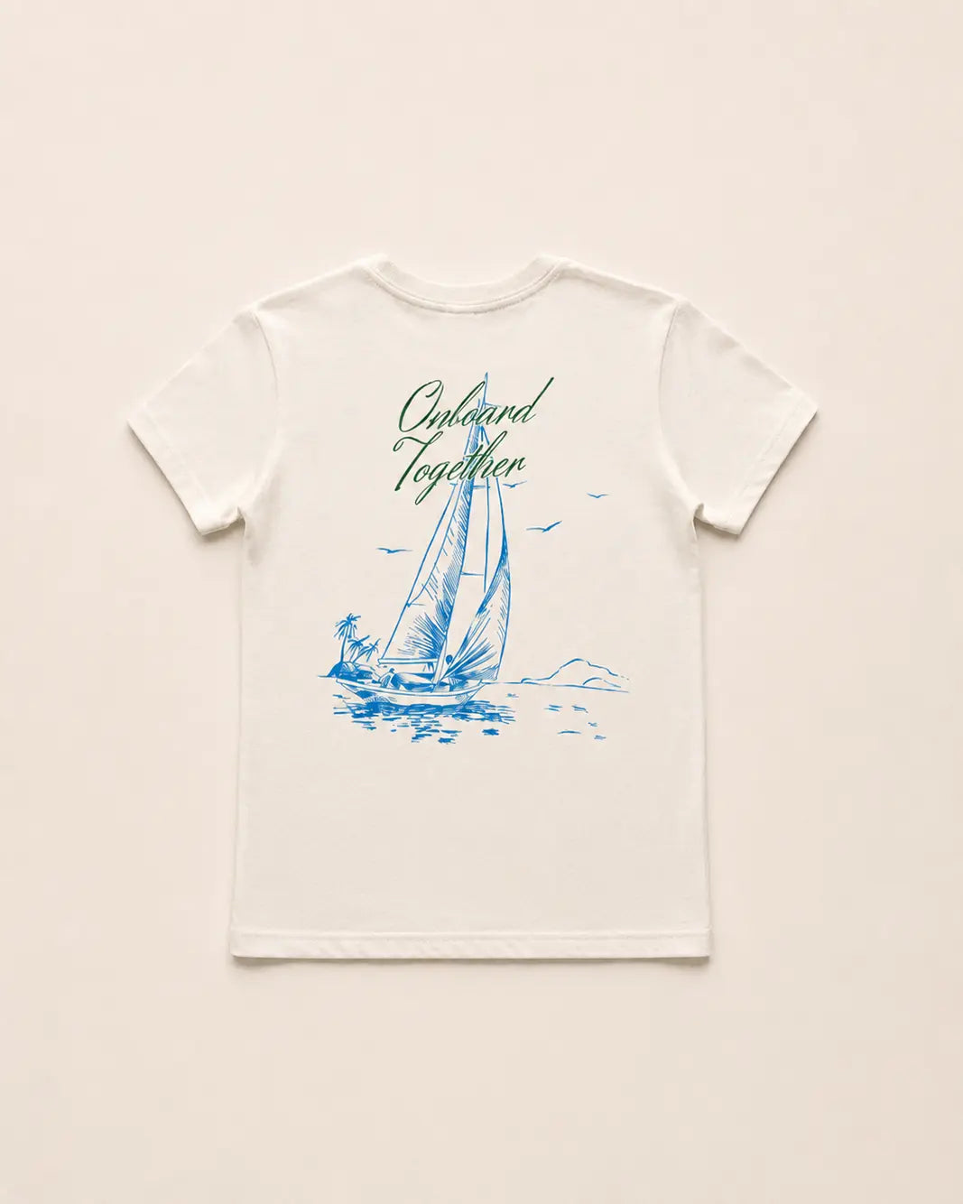 White t-shirt with blue sailboat graphic and text on a beige background