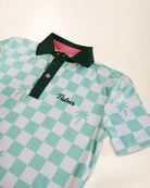 A short-sleeve polo shirt with a mint green and white checkered pattern, featuring a dark green collar and placket, a pink inner lining, and the name 'Palmr' embroidered on the chest.