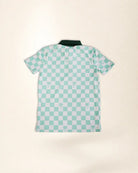 A short-sleeve polo shirt with a mint green and white checkerboard pattern and small palm tree motifs, laid flat on a light beige background.