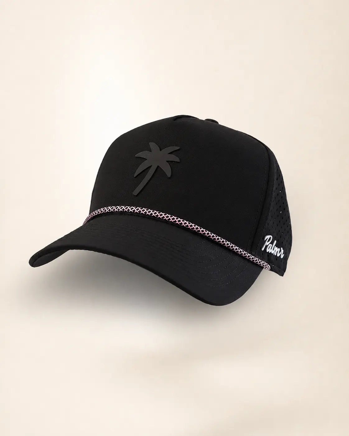 A black trucker-style baseball cap with a black palm tree logo on the front, a silver chain detail across the brim, and white script embroidery on the side mesh, shown against a plain off-white background.