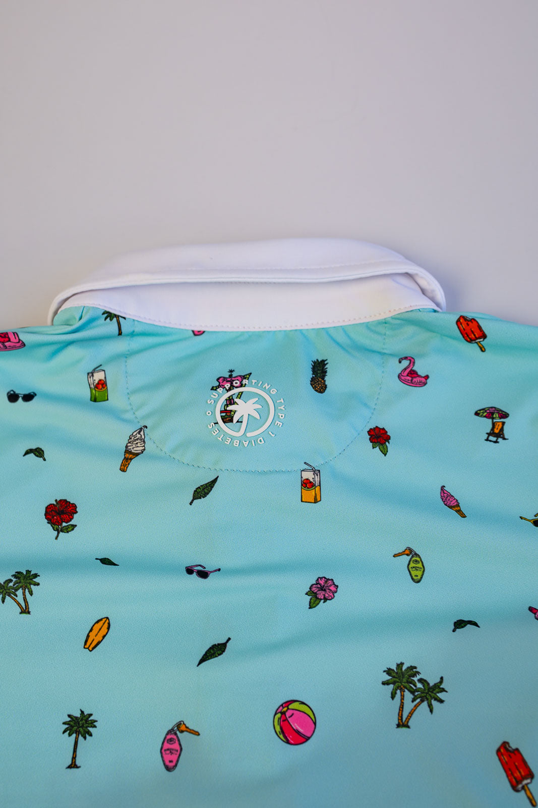 Light blue shirt with colorful patterns on a white background
