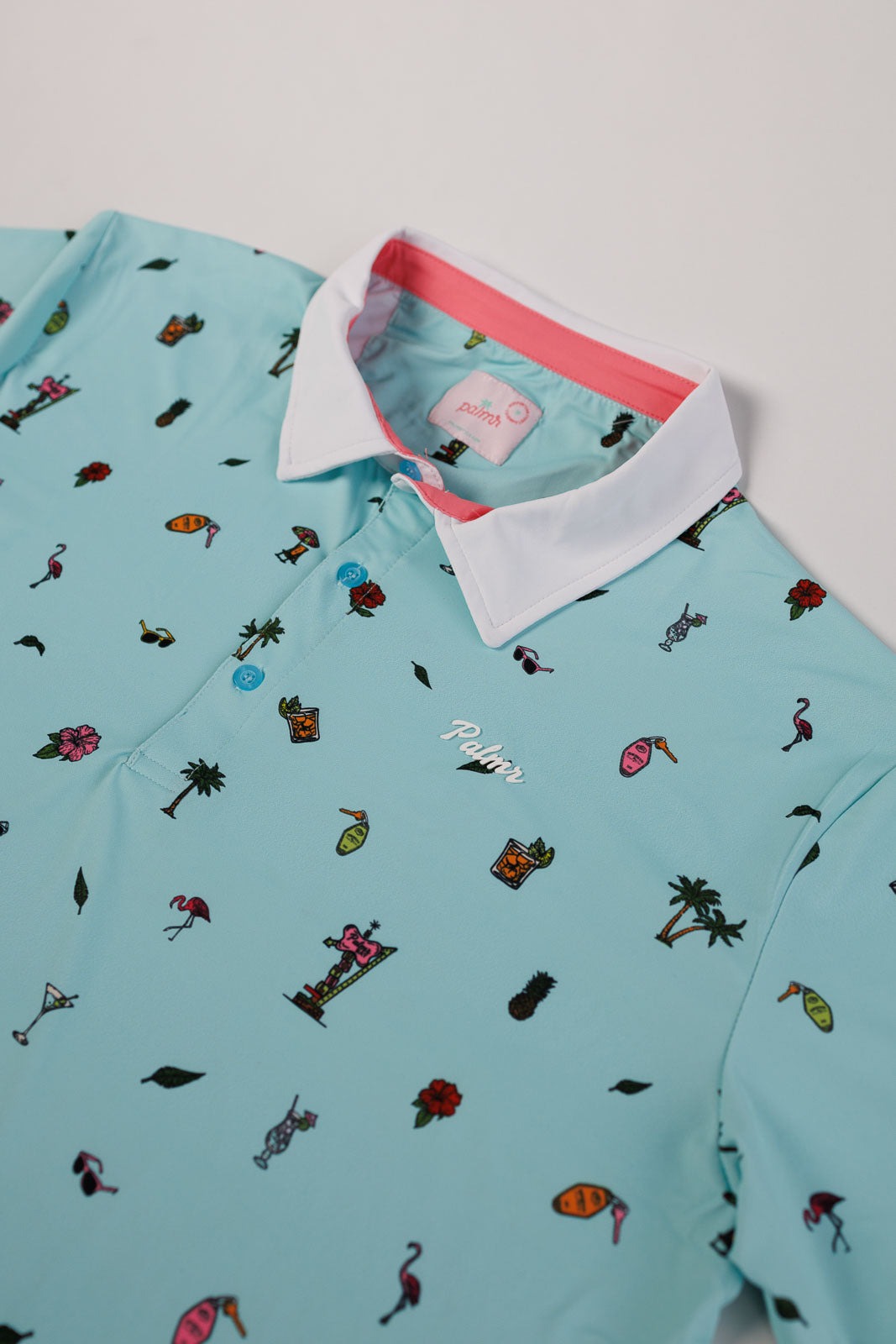 Light blue polo shirt with colorful pattern on a white background