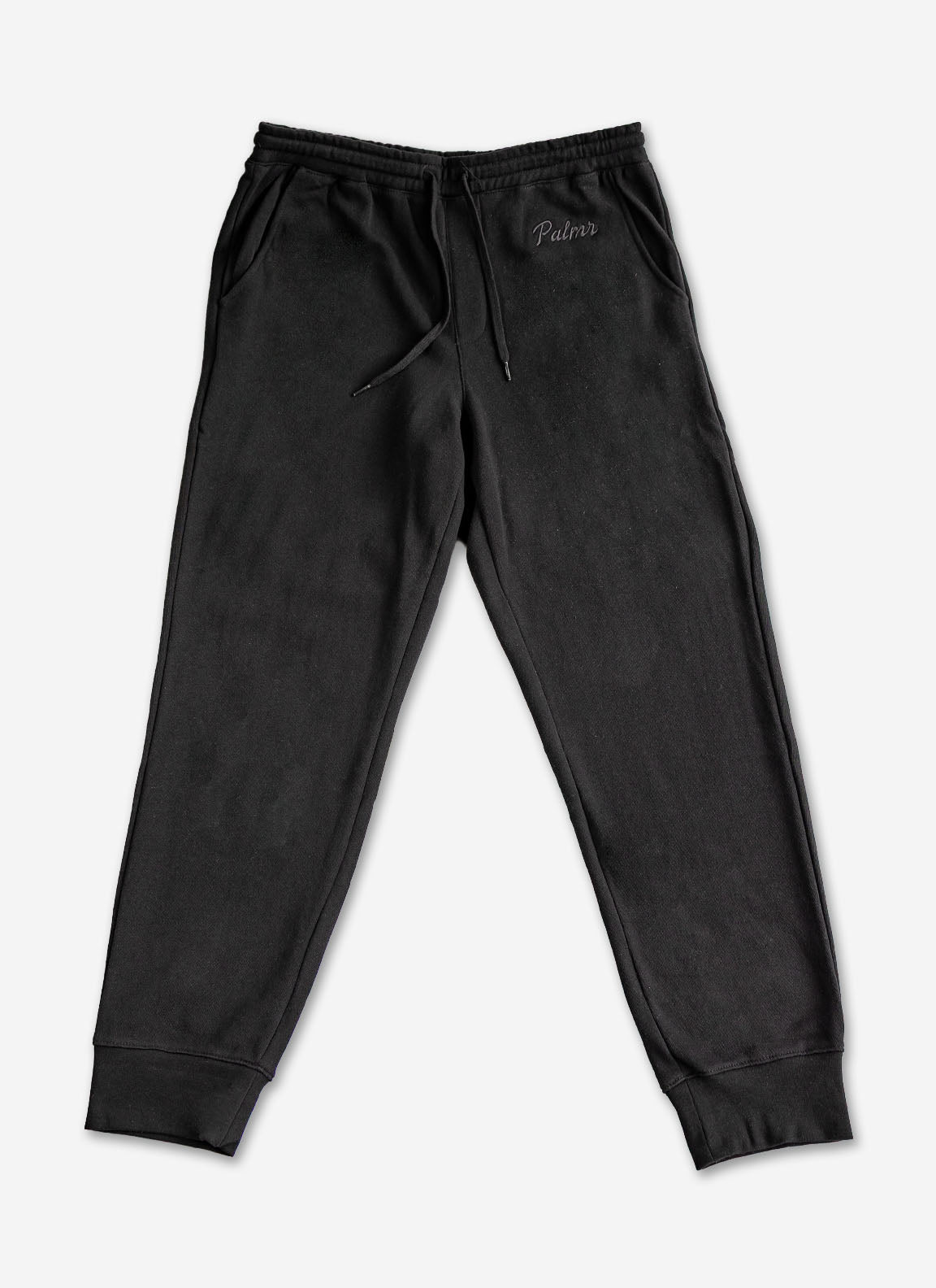 Black sweatpants with a brand logo on a white background