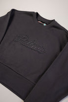 Black sweatshirt with 'Palace' branding on a light gray background