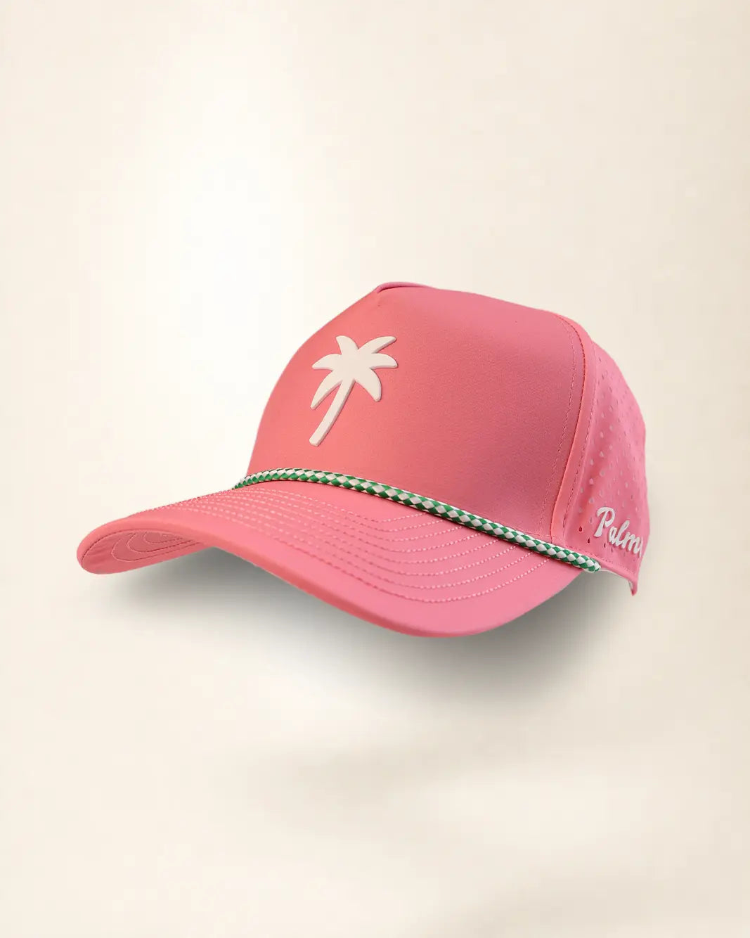 A pink baseball cap with a white palm tree logo on the front, a green and white braided trim across the brim, and 'Palm' embroidered in white on the side, shown against a light beige background.