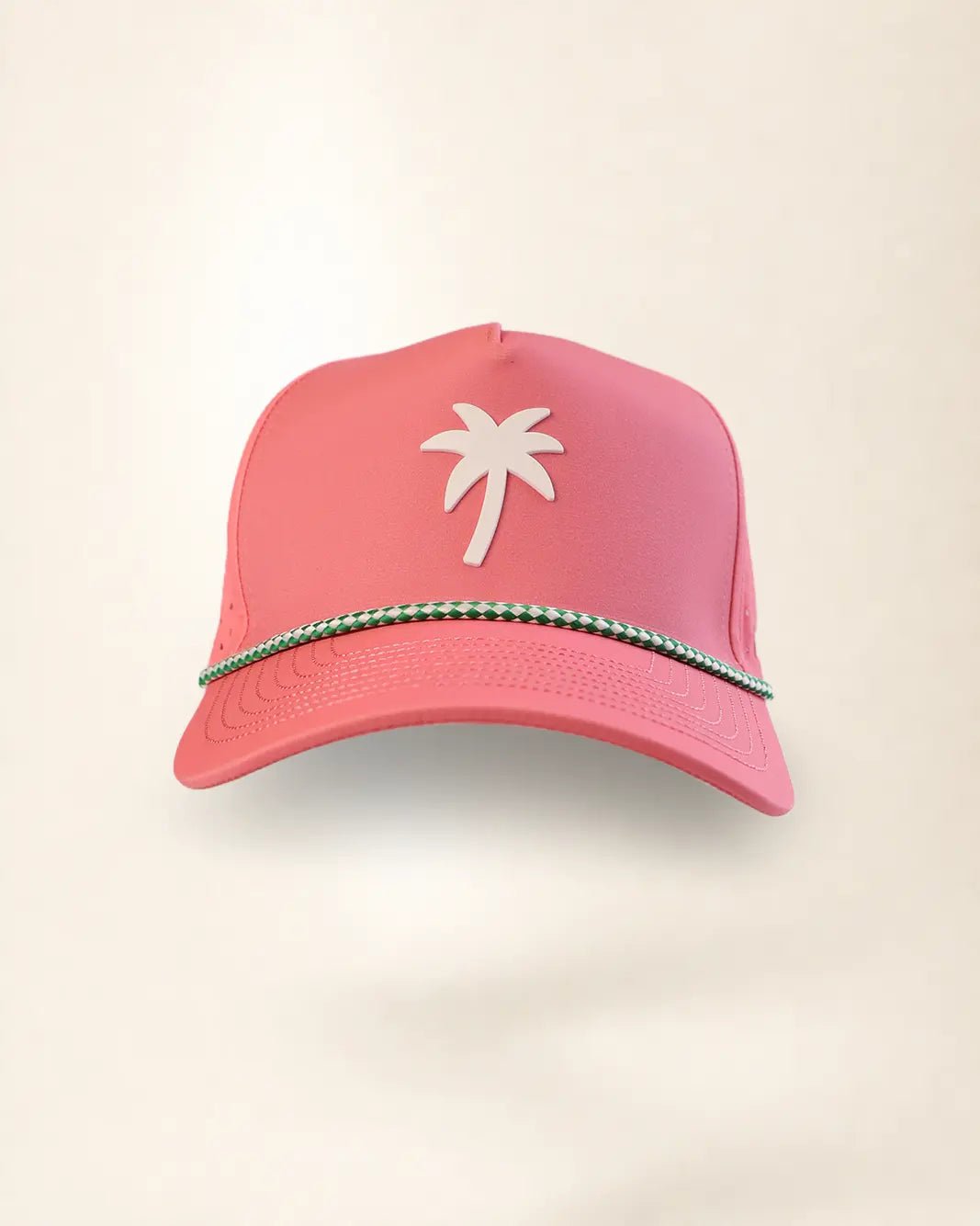 A pink baseball cap featuring a white palm tree logo on the front and a decorative green and white beaded trim along the brim, set against a plain off-white background.