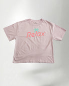 Light pink t-shirt with 'Relax' printed on it against a plain background