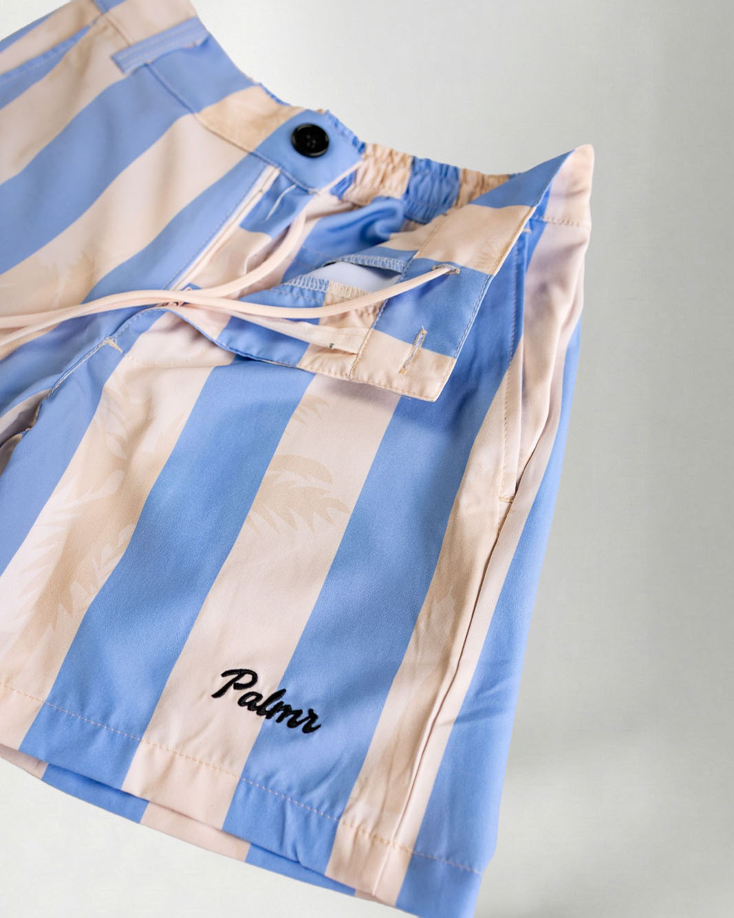 Blue and beige striped jacket with 'Palmr' branding on a light gray background