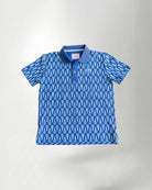 Child wearing a blue patterned polo shirt and cap with a white background