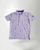 Patterned polo shirt and cap on a plain background