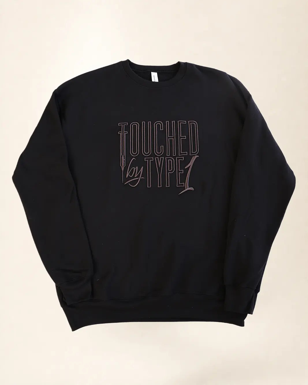 Black sweatshirt with 3d stylized embroidery lettering that says 'Touched By Type 1'