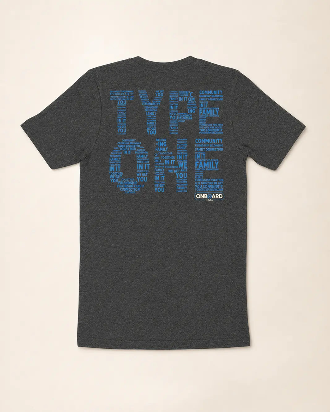 Gray t-shirt with blue text on the back against a beige background