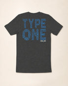 Gray t-shirt with blue text on the back against a beige background