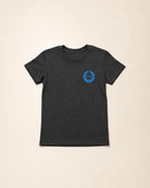 Dark gray t-shirt with a blue logo on a beige background