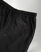 Black pants with the Palmr logo embroidery in jogger style