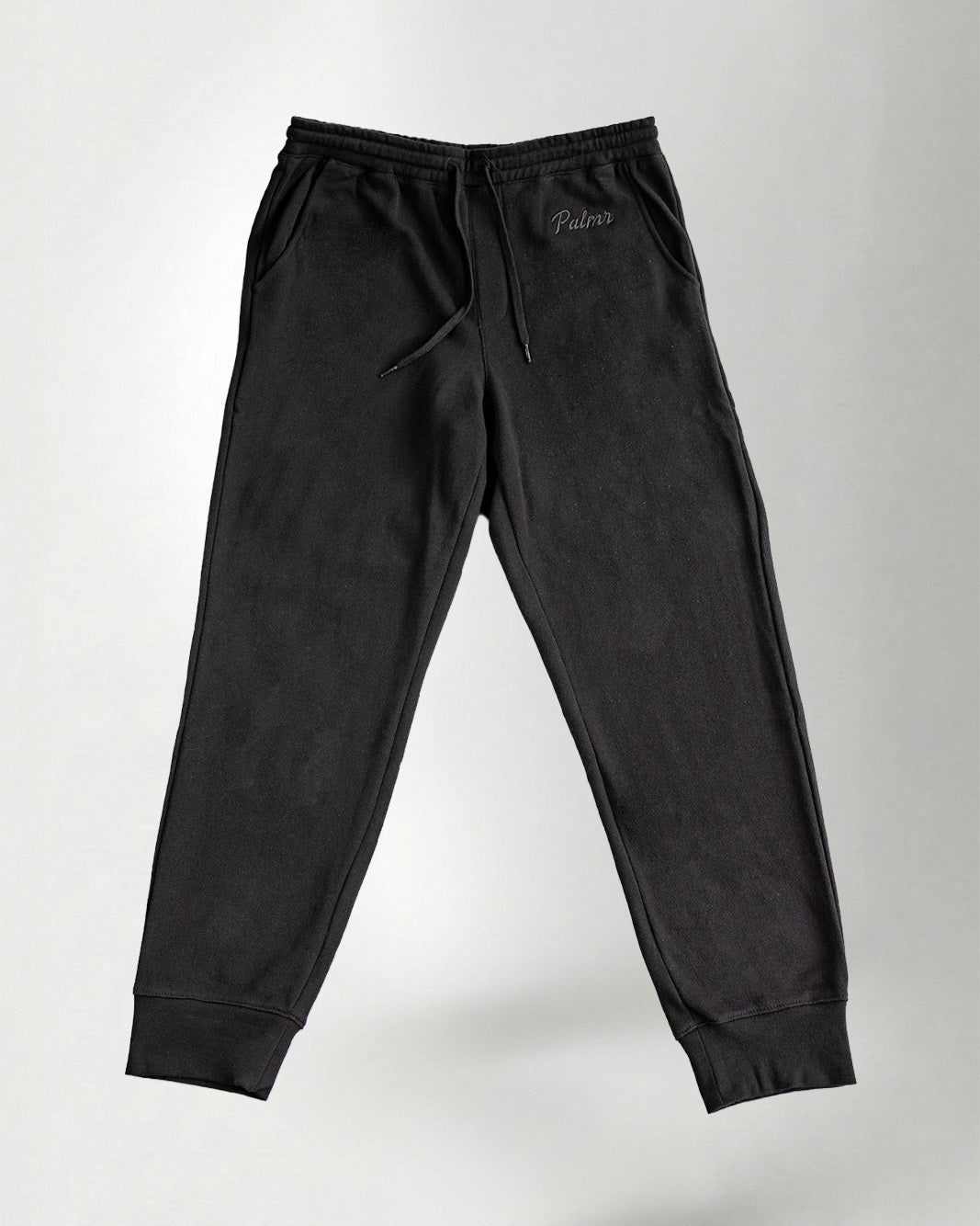 Black pants with the Palmr logo embroidery in jogger style