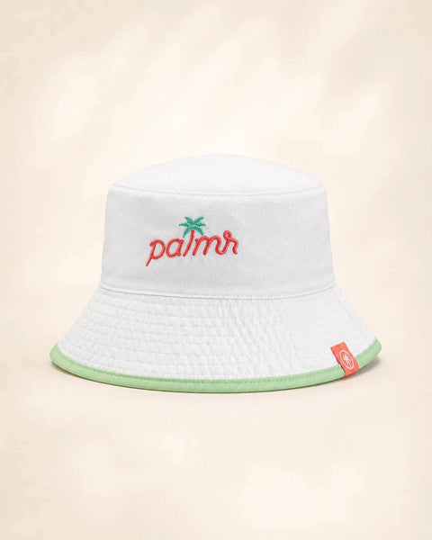 The Parker Reversible Bucket Hat: white bucket hat, Palmr embroidered in red with a green palm tree on the front, light green trim on the brim.