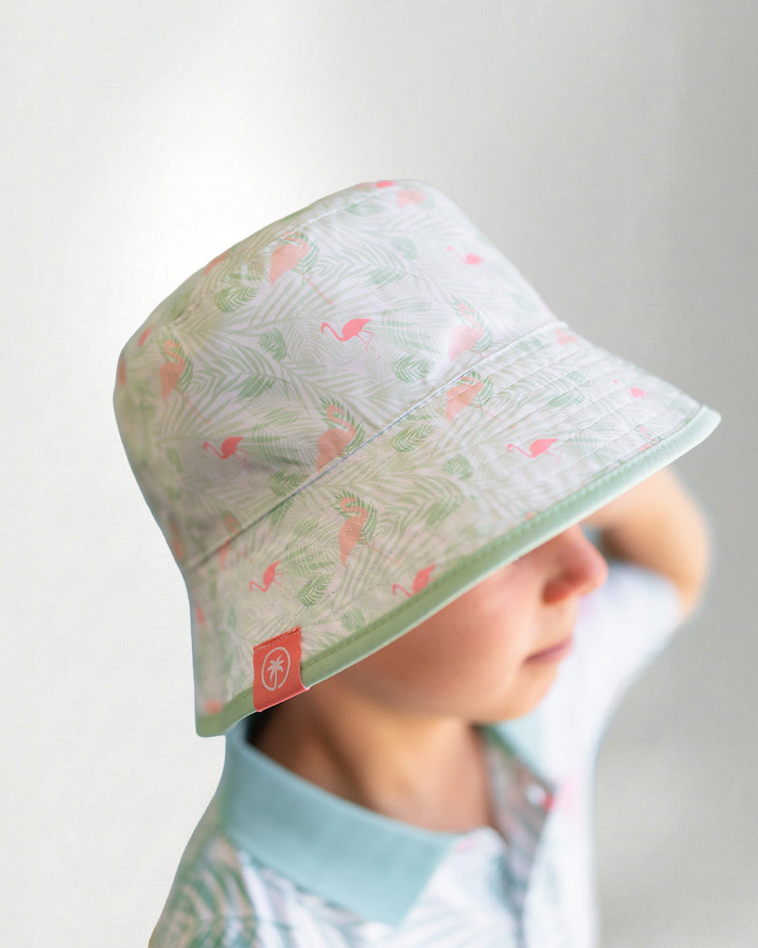 White bucket hat with a color tropical pattern.