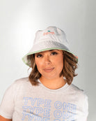 White bucket hat with a "Palmr" logo in embroidery