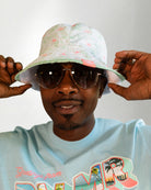 White bucket hat  with a color tropical pattern.