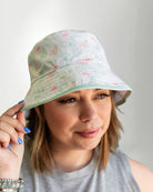 White bucket hat with a color tropical pattern.