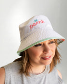 White bucket hat with a "Palmr" logo in embroidery